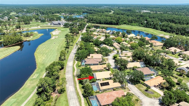 438 Harbour Town Ln, Ormond Beach, FL 32174 - aerial perspective of suburban area featuring a nearby body of water, a local golf course, and a heavily wooded area