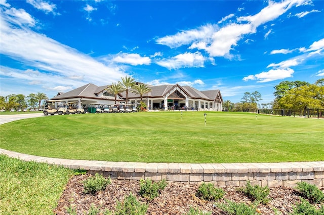 438 Harbour Town Ln, Ormond Beach, FL 32174 - view of front facade featuring a putting green, a front yard, and view of golf course