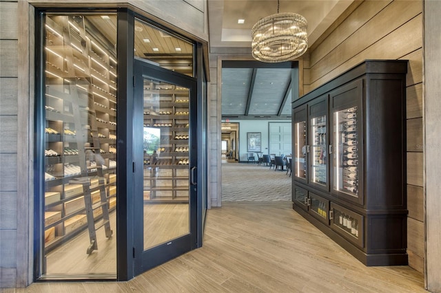 438 Harbour Town Ln, Ormond Beach, FL 32174 - wine cellar with a chandelier, light wood-type flooring, and a high ceiling