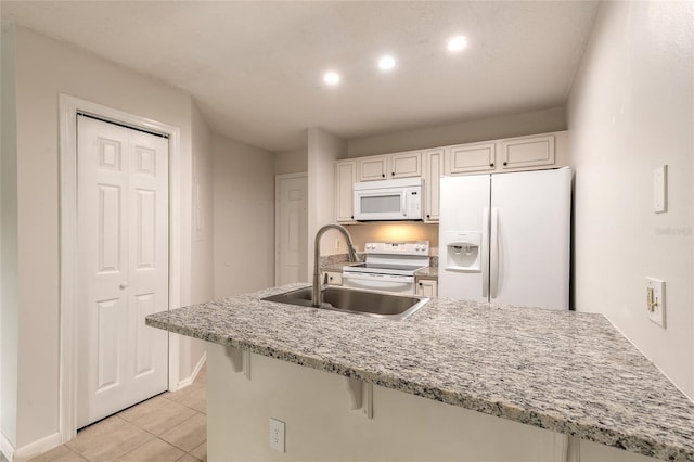 1401 S Palmetto Ave Unit 119, Daytona Beach, FL 32114 - kitchen with white appliances, a sink, baseboards, light tile patterned floors, and white cabinets