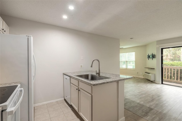 1401 S Palmetto Ave Unit 119, Daytona Beach, FL 32114 - kitchen with a sink, a textured ceiling, white appliances, recessed lighting, and white cabinets