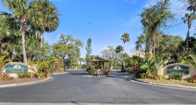1401 S Palmetto Ave Unit 119, Daytona Beach, FL 32114 - view of asphalt road with curbs, a gate, and a gated entry
