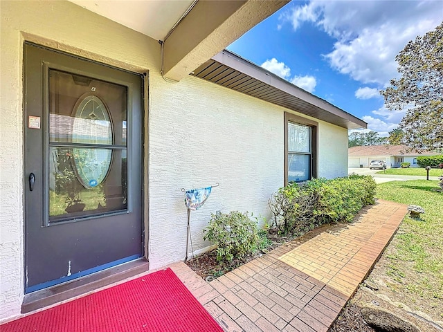 12 Emmons Ln Unit A & B, Palm Coast, FL 32164 - doorway to property with stucco siding