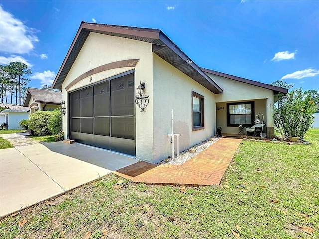 12 Emmons Ln Unit A & B, Palm Coast, FL 32164 - view of side of property with stucco siding, driveway, an attached garage, and a yard