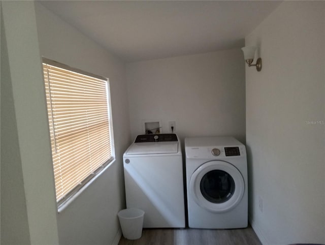 20422 Canvas Back Rd, Altoona, FL 32702 - laundry room with washing machine and clothes dryer, wood finished floors, and baseboards