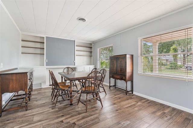 1411 Cliff Ave, Eustis, FL 32726 - dining room featuring ornamental molding, wood finished floors, and baseboards