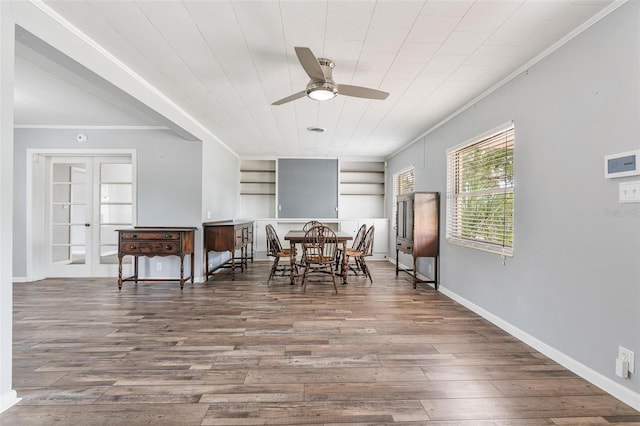 1411 Cliff Ave, Eustis, FL 32726 - dining space featuring crown molding, ceiling fan, wood finished floors, built in shelves, and baseboards