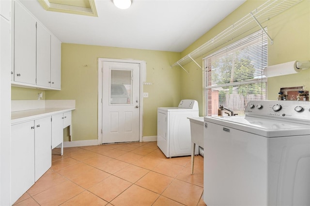 1411 Cliff Ave, Eustis, FL 32726 - washroom with cabinet space, separate washer and dryer, light tile patterned floors, and baseboards