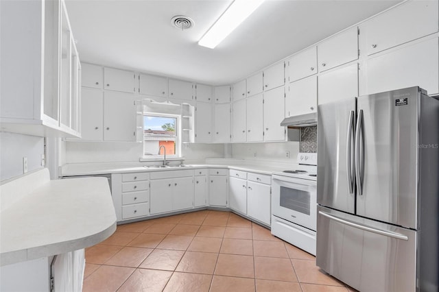 1411 Cliff Ave, Eustis, FL 32726 - kitchen with freestanding refrigerator, white electric stove, a sink, under cabinet range hood, and white cabinetry