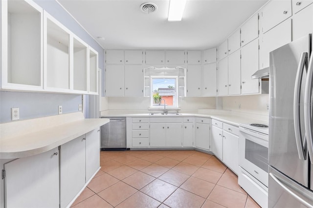1411 Cliff Ave, Eustis, FL 32726 - kitchen with appliances with stainless steel finishes, under cabinet range hood, a sink, and white cabinetry