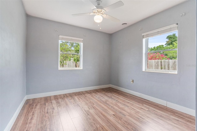 1411 Cliff Ave, Eustis, FL 32726 - unfurnished room with light wood-style floors, ceiling fan, and baseboards