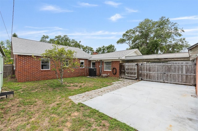 1411 Cliff Ave, Eustis, FL 32726 - rear view of property with cooling unit, brick siding, and a patio
