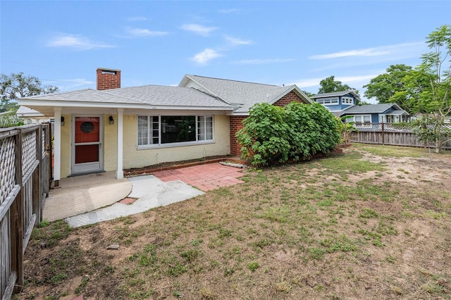 1411 Cliff Ave, Eustis, FL 32726 - view of front facade with a chimney, brick siding, and a shingled roof