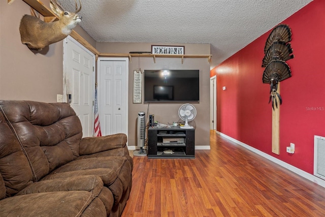137 Fort Smith Blvd, Deltona, FL 32738 - living room featuring wood finished floors, baseboards, and a textured ceiling