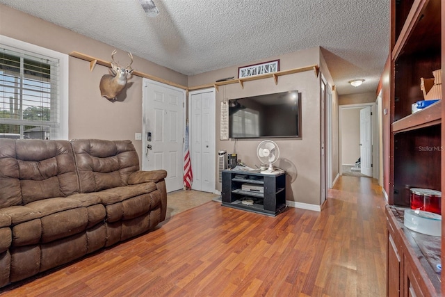 137 Fort Smith Blvd, Deltona, FL 32738 - living room featuring wood finished floors, baseboards, and a textured ceiling