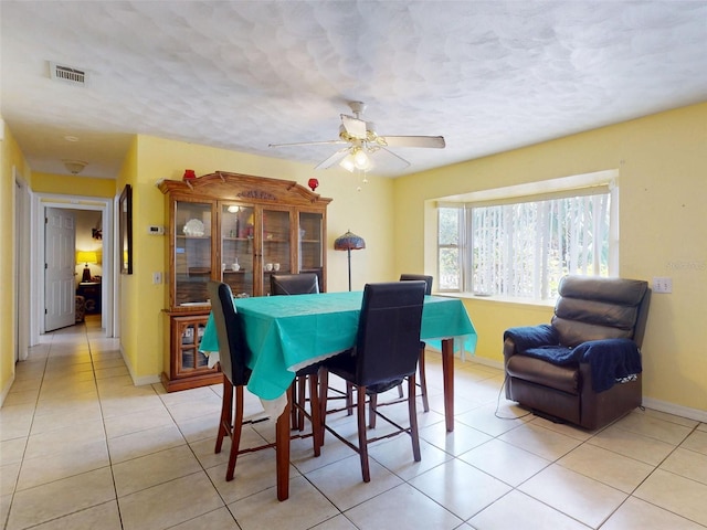 1229 Jeffery Dr, Port Orange, FL 32129 - dining area with light tile patterned floors, baseboards, ceiling fan, and a textured ceiling