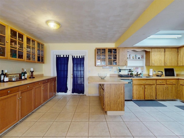 1229 Jeffery Dr, Port Orange, FL 32129 - kitchen featuring dishwasher, light countertops, a peninsula, open shelves, and glass insert cabinets
