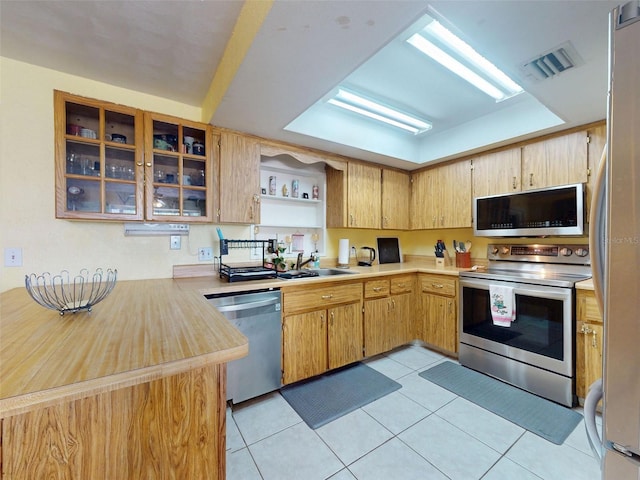 1229 Jeffery Dr, Port Orange, FL 32129 - kitchen with appliances with stainless steel finishes, a sink, light countertops, and light tile patterned floors