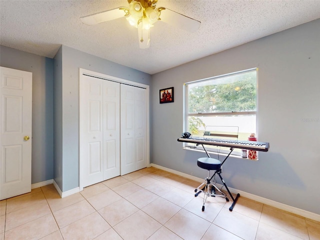 1229 Jeffery Dr, Port Orange, FL 32129 - bedroom featuring a closet, a textured ceiling, tile patterned flooring, a ceiling fan, and baseboards