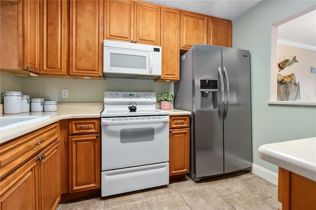 2711 N Halifax Ave Unit 264, Daytona Beach, FL 32118 - kitchen with white appliances, brown cabinetry, light countertops, and crown molding