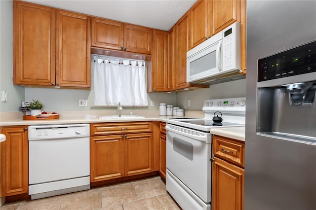 2711 N Halifax Ave Unit 264, Daytona Beach, FL 32118 - kitchen with white appliances, a sink, and brown cabinets