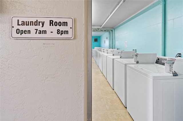2711 N Halifax Ave Unit 264, Daytona Beach, FL 32118 - community laundry room featuring washer and dryer, light tile patterned flooring, and a textured wall
