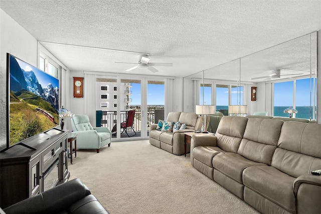 2987 S Atlantic Ave Unit 901, Daytona Beach, FL 32118 - carpeted living room with a textured ceiling, a ceiling fan, and a water view