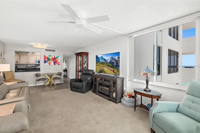 2987 S Atlantic Ave Unit 901, Daytona Beach, FL 32118 - carpeted living area featuring a textured ceiling and ceiling fan