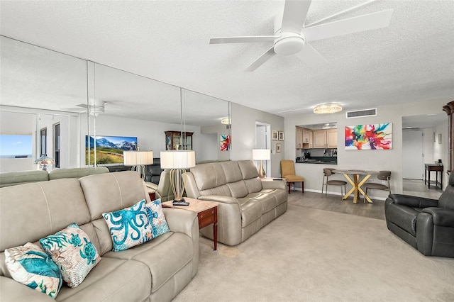 2987 S Atlantic Ave Unit 901, Daytona Beach, FL 32118 - living room featuring ceiling fan, a textured ceiling, and light carpet
