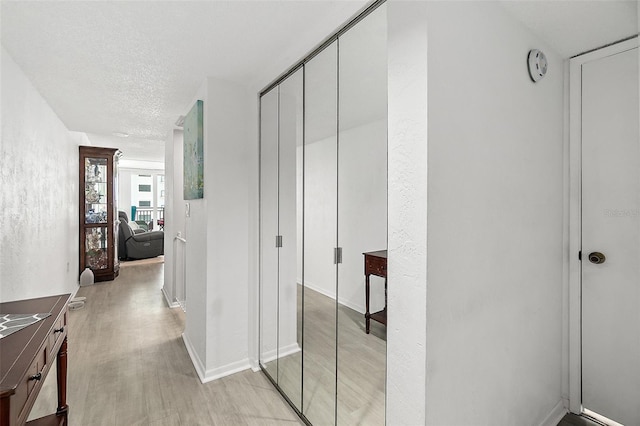 2987 S Atlantic Ave Unit 901, Daytona Beach, FL 32118 - corridor featuring light wood-style flooring and a textured ceiling