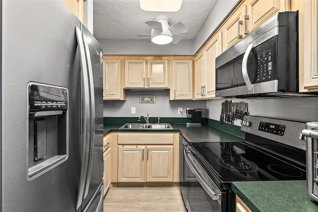 2987 S Atlantic Ave Unit 901, Daytona Beach, FL 32118 - kitchen featuring stainless steel appliances, dark countertops, ceiling fan, light brown cabinets, and a textured ceiling