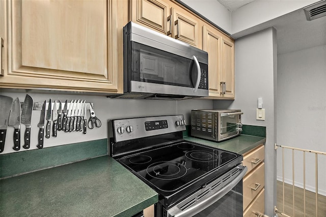 2987 S Atlantic Ave Unit 901, Daytona Beach, FL 32118 - kitchen with stainless steel appliances, dark countertops, and light brown cabinets