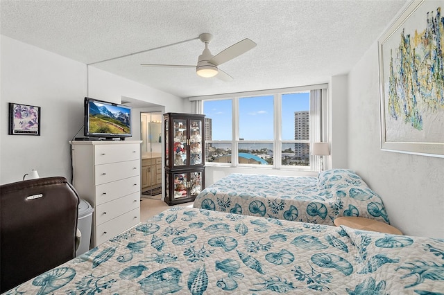 2987 S Atlantic Ave Unit 901, Daytona Beach, FL 32118 - bedroom featuring a textured ceiling, a ceiling fan, and ensuite bathroom