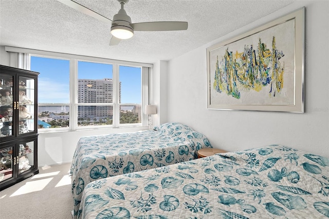 2987 S Atlantic Ave Unit 901, Daytona Beach, FL 32118 - carpeted bedroom with a textured ceiling, ceiling fan, and a city view