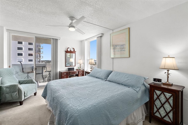 2987 S Atlantic Ave Unit 901, Daytona Beach, FL 32118 - carpeted bedroom featuring a textured ceiling, access to exterior, and a ceiling fan