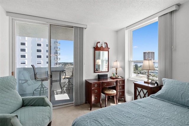 2987 S Atlantic Ave Unit 901, Daytona Beach, FL 32118 - bedroom with access to outside, carpet floors, a textured ceiling, and floor to ceiling windows