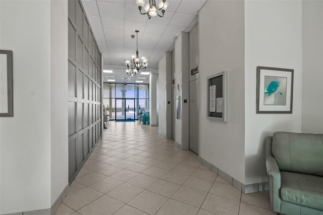 2987 S Atlantic Ave Unit 901, Daytona Beach, FL 32118 - corridor with a chandelier, a wall of windows, and light tile patterned floors