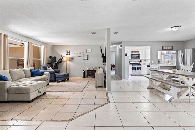 833 Lucerne Cir, Ormond Beach, FL 32174 - living area featuring light tile patterned floors and a textured ceiling