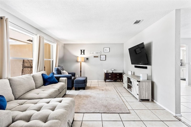833 Lucerne Cir, Ormond Beach, FL 32174 - living room with light tile patterned flooring, a textured ceiling, and baseboards