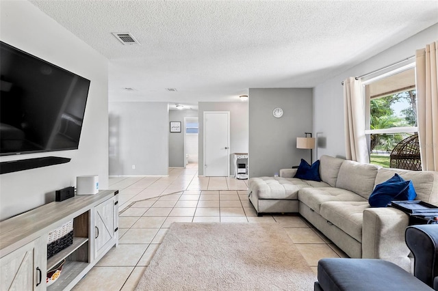 833 Lucerne Cir, Ormond Beach, FL 32174 - living room featuring light tile patterned floors and a textured ceiling