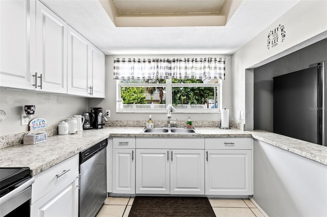 833 Lucerne Cir, Ormond Beach, FL 32174 - kitchen with stainless steel appliances, a sink, light tile patterned flooring, and white cabinetry