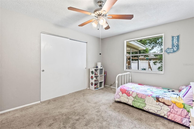 833 Lucerne Cir, Ormond Beach, FL 32174 - carpeted bedroom featuring a textured ceiling, a ceiling fan, and a closet