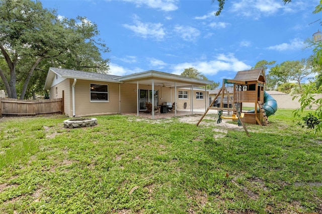 833 Lucerne Cir, Ormond Beach, FL 32174 - back of house featuring a playground, a patio area, an outdoor fire pit, and a ceiling fan