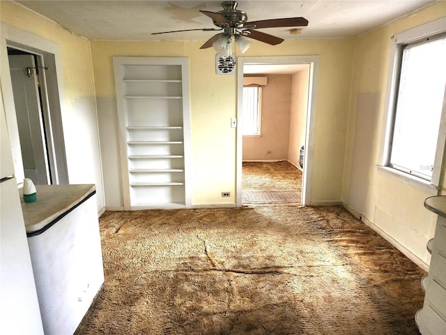 2647 Brookline Ave, New Smyrna Beach, FL 32168 - unfurnished dining area with built in features, carpet flooring, and ceiling fan