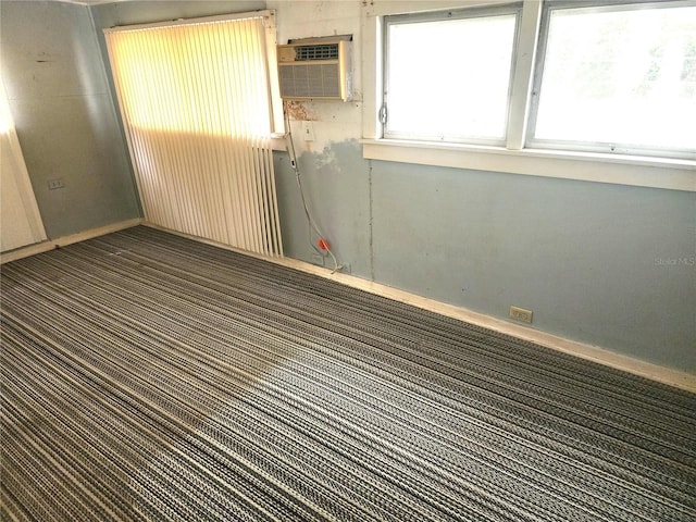 2647 Brookline Ave, New Smyrna Beach, FL 32168 - carpeted spare room featuring baseboards and a wall mounted air conditioner