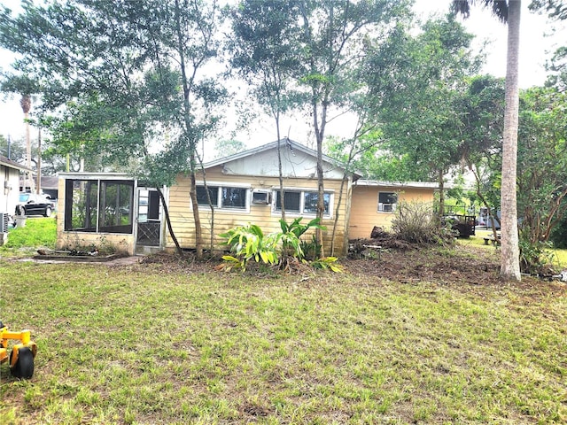 2647 Brookline Ave, New Smyrna Beach, FL 32168 - rear view of house with a sunroom, a yard, and a wall mounted AC