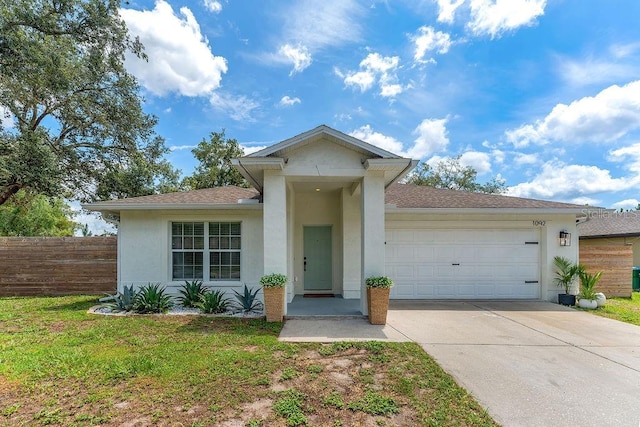 1092 Gage Ave, Deltona, FL 32738 - ranch-style home featuring stucco siding, concrete driveway, an attached garage, and roof with shingles