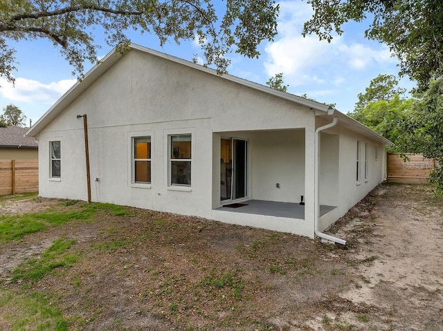 1092 Gage Ave, Deltona, FL 32738 - rear view of property with stucco siding and a patio area
