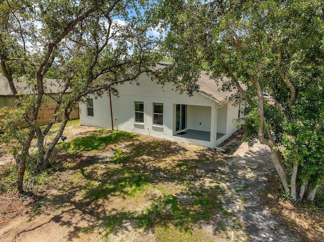 1092 Gage Ave, Deltona, FL 32738 - rear view of house with a patio and stucco siding