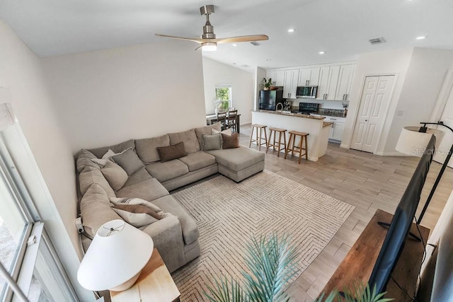 1092 Gage Ave, Deltona, FL 32738 - living area featuring ceiling fan, vaulted ceiling, recessed lighting, and light wood-type flooring